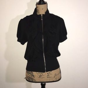 Short sleeve jacket with zipper and ruffles.